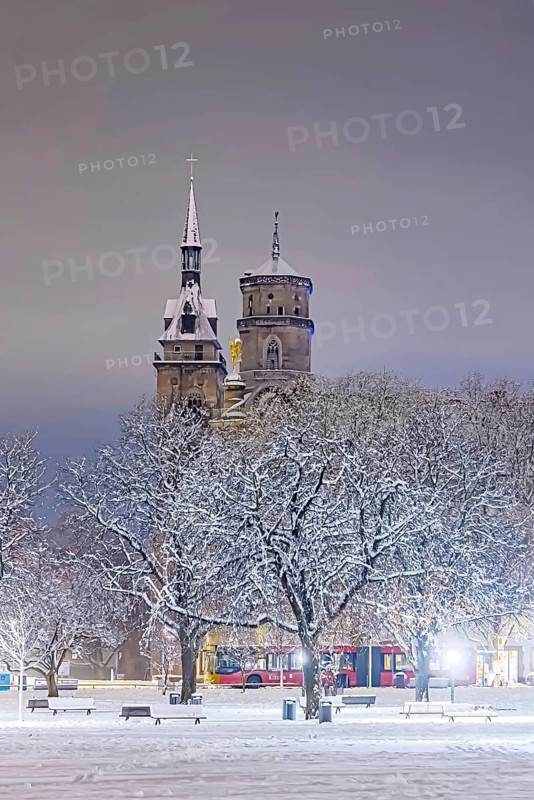 Winter in Stuttgart. The city is wintry white early in the morning. Castle square with collegiate church. Stuttgart, Baden-Württemberg, Germany