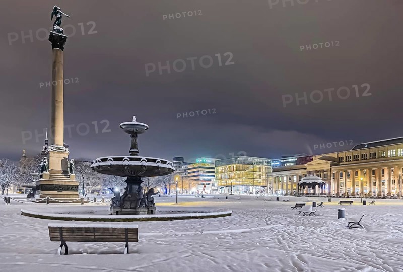 Winter in Stuttgart. It snowed overnight and the city is wintry white early in the morning. Palace Square with anniversary column, royal building and art museum. Stuttgart, Baden-Württemberg, Germany