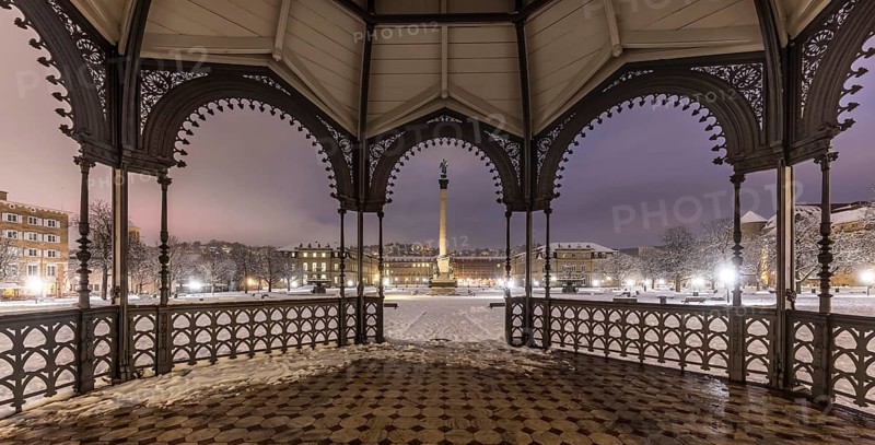 Winter in Stuttgart. It snowed overnight and the city is wintry white early in the morning. View of Schlossplatz and the New Palace through the bandstand. Stuttgart, Baden-Württemberg, Germany