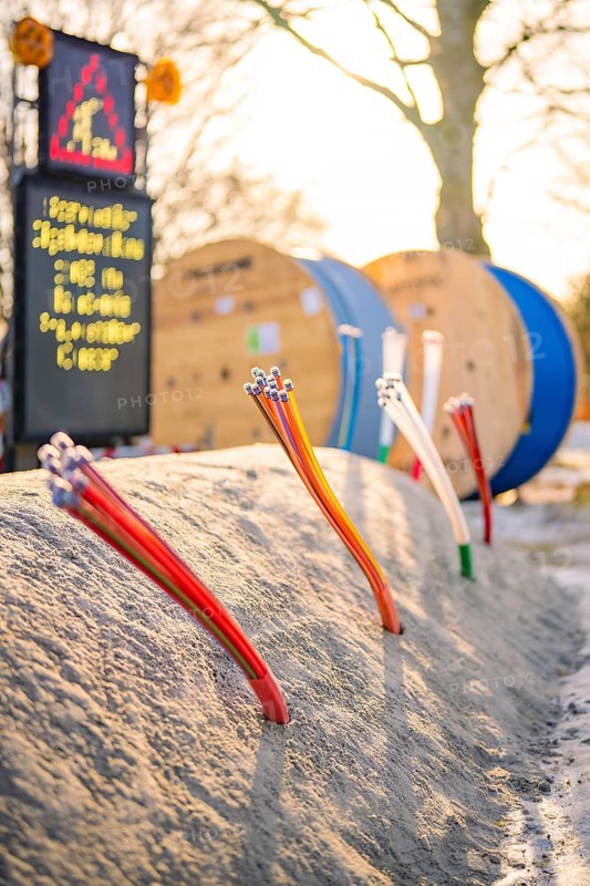 Various thin cables stick out of the ground of a construction site, fiberglass groundbreaking, Freudenstadt, Germany