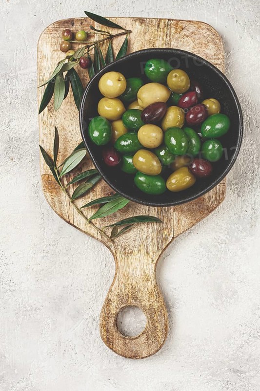 A mixture of olives, varieties of chalkidiki, Verdi giganti and Kalamata, in a bowl, top view, no people
