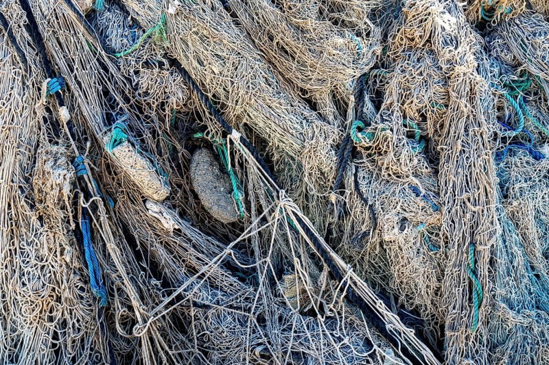 Close-up view of old fishing net hanging on boat, Oman
