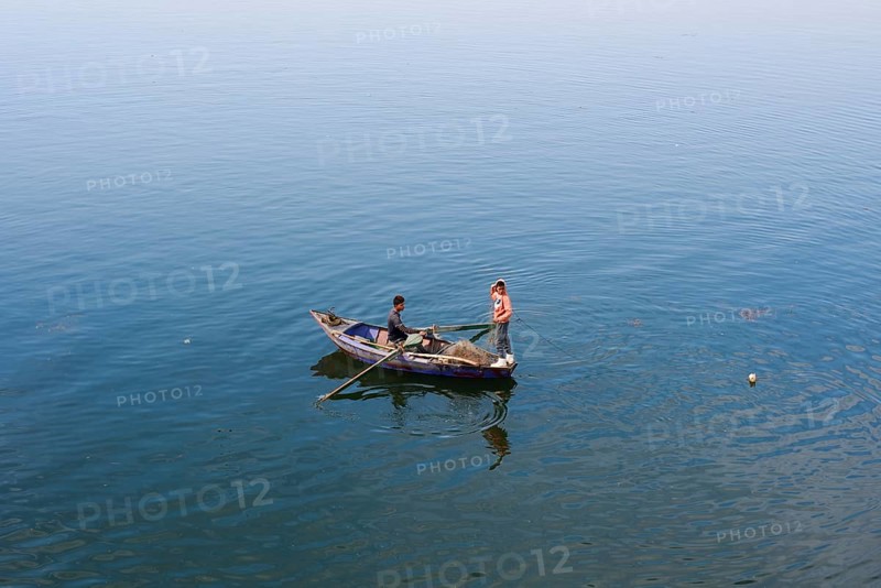 Boys in a rowboat fishing on the Nile, Luxor, Egypt