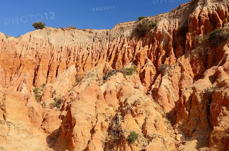 Eroded sandstone cliffs on the coast, Praia da Mesquita, Algarve, Portugal