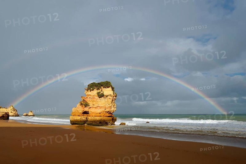 Rocks on beach with rainbow, Praia Dona Ana, Lagos, Algarve, Portugal