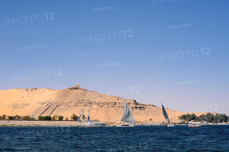 Qubbet el-Hawa with the rock tombs on the Nile, Aswan, Egypt