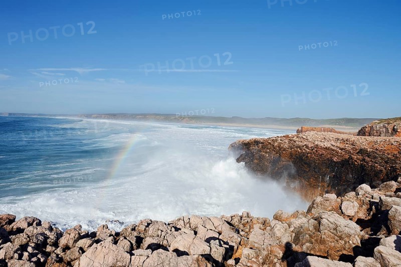 Surf with rainbow on the rocky coast, Carrapateira, Parque Natural do Sudoeste Alentejano e Costa Vicentina, Algarve, Portugal