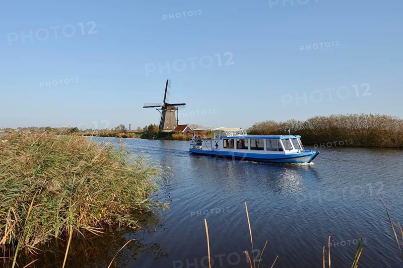 Historic windmill and sightseeing boat, UNESCO World Heritage Site, Kinderdijk, South Holland, Netherlands