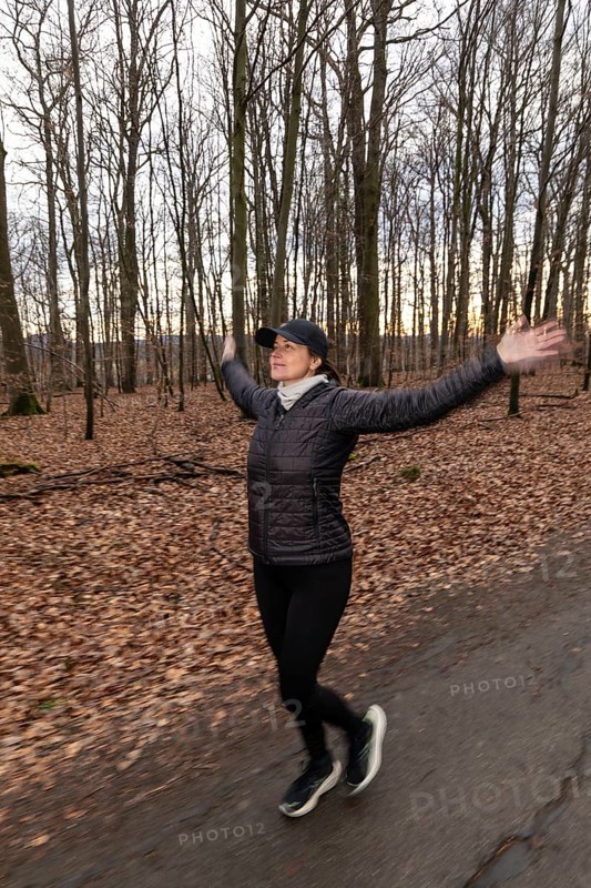Woman jogging and doing sport exercise in winter nature. Germany