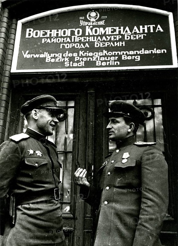 Two Soviet soldiers in front of the administration of the war commander for the district of Prenzlauer Berg, June 1945, Berlin, Germany