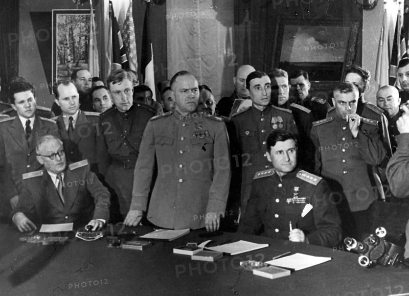 Signing of the unconditional surrender of the fascist German Wehrmacht on May 8, 1945 in Berlin - Karlshorst. As representative of the High Command of the Red Army, Marshal of the Soviet Union G. K. Zhukov signs the surrender document, on the left the Deputy Soviet Foreign Minister A. J. Vyshinsky, on the right Army General V.D. Sokolovsky