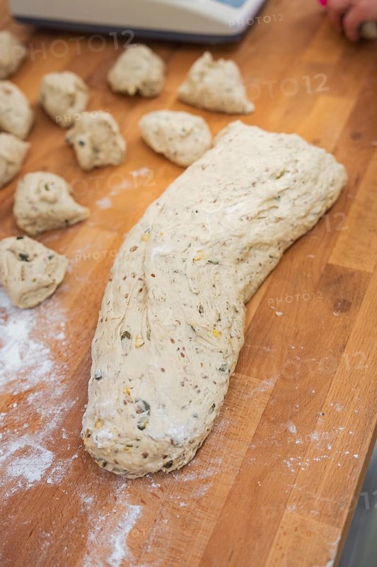 A large lump of dough and small pieces of dough on a floured wooden table, baking rolls, Haselstaller Hof, Gechingen, Germany