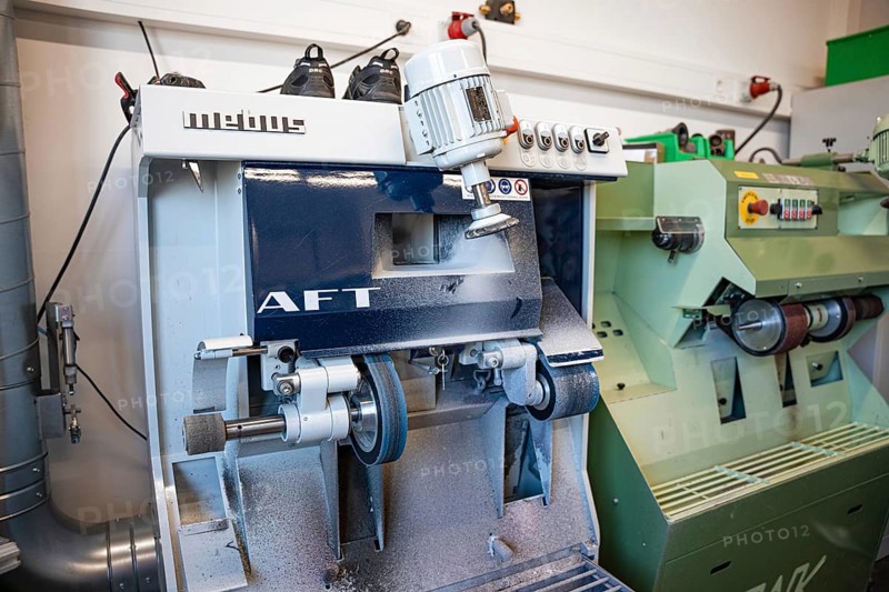 Industrial grinding machine in a metalworking workshop, medical supply store