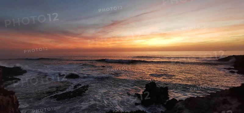Sunset on the fishing trail over the sea with calm waves and colorful skies, Southwest Alentejo nature park Park, Vicentina Coast, Portugal