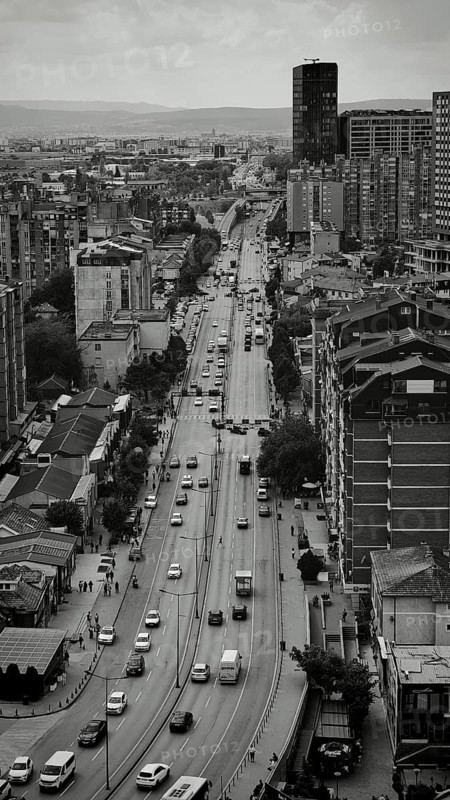 Urban scene in black and white with high-rise buildings and busy road. Pristina, Kosovo