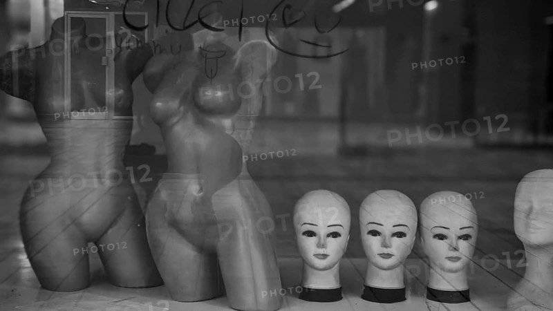 Shop window with mannequins and heads in a melancholy black and white atmosphere, Skopje, Macedonia