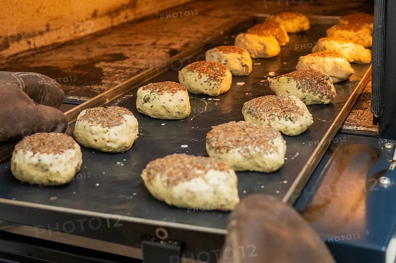 Several rolls with linseed in a warm oven on a baking tray, bake rolls, Haselstaller Hof, Gechingen, Germany