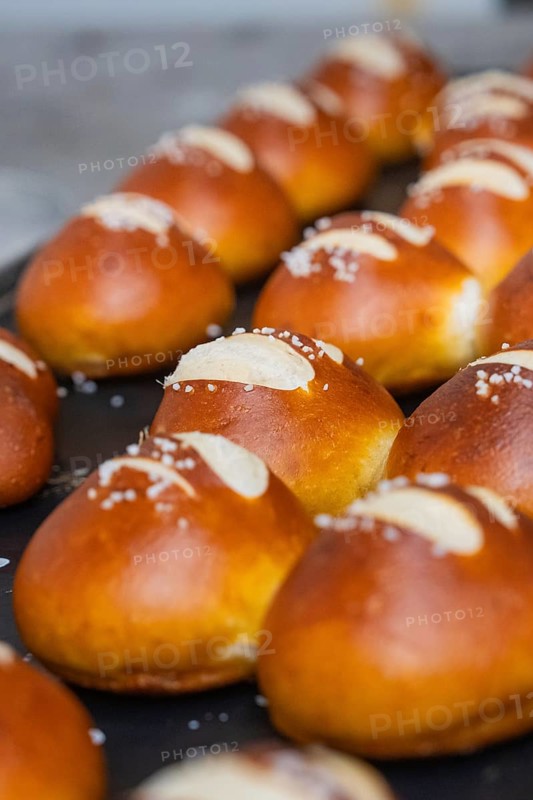 Fresh, golden brown pretzel rolls with salt streusel lie on a baking tray, bake rolls, Haselstaller Hof, Gechingen, Germany