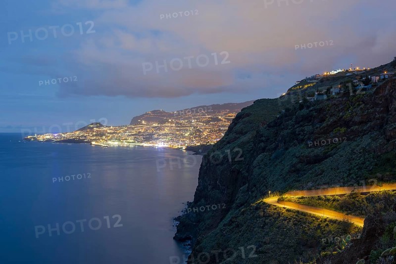 View of the Atlantic Ocean from Christo Rei viewpoint at dusk, harbour with cruise ships and Funchal, Madeira, Portugal