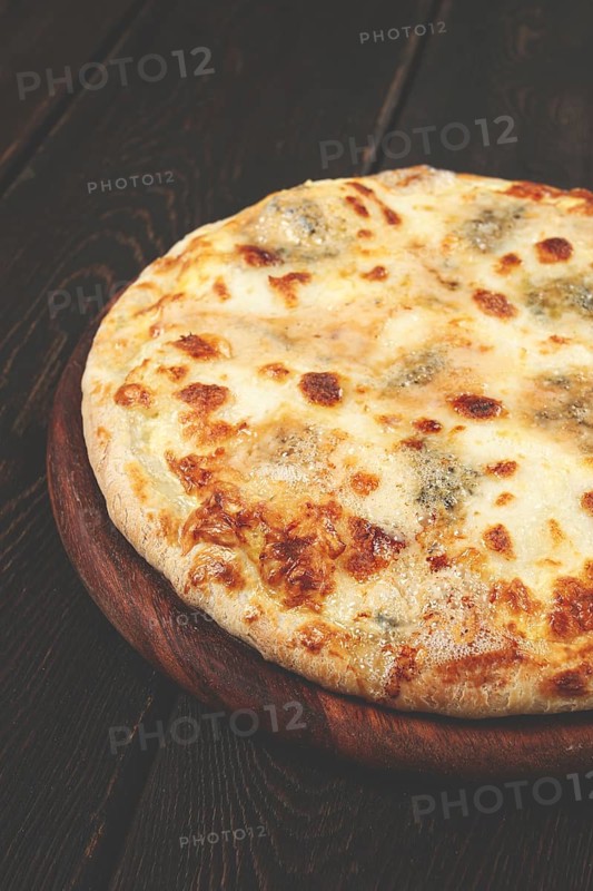 Freshly baked cheese pizza, with a golden crust and bubbling melted cheese, white pizza, on a wooden board, homemade, no people