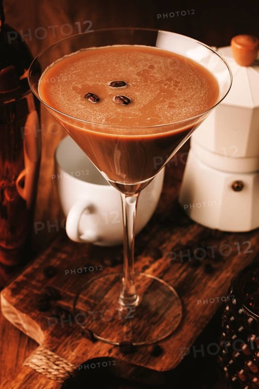 Espresso martini cocktail, alcoholic drink, shaker and geyser coffee maker, on a wooden background