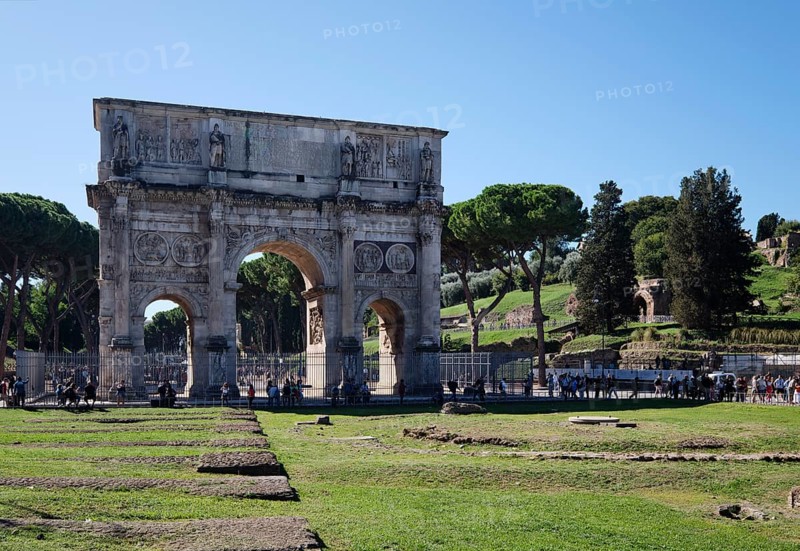 Arch of Constantine with tourists on sunny day, Lazio, Italy