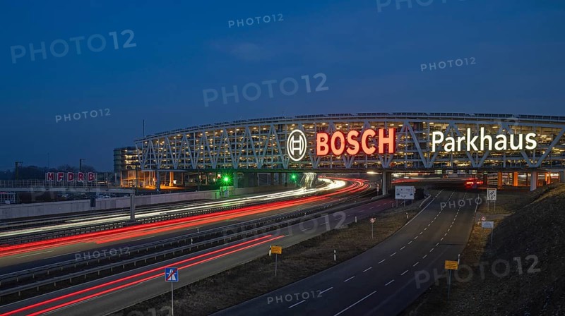 Traffic on the A8 motorway, blue hour, illuminated parking garage, Landesmesse Stuttgart, red-lit Bosch logo, second-largest logo in the world 55 meters wide, Baden-Württemberg, Germany