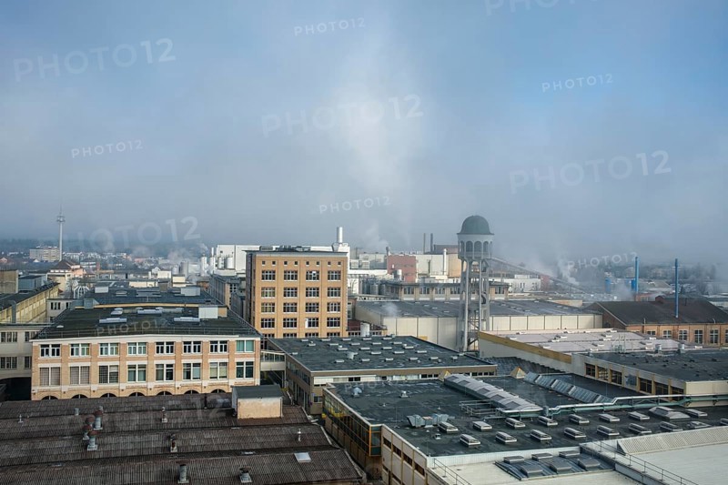 View of the industrial area of Singen am Hohentwiel with industrial buildings and hazy morning sky, Hegau, Konstanz district, Baden-Württemberg, Germany