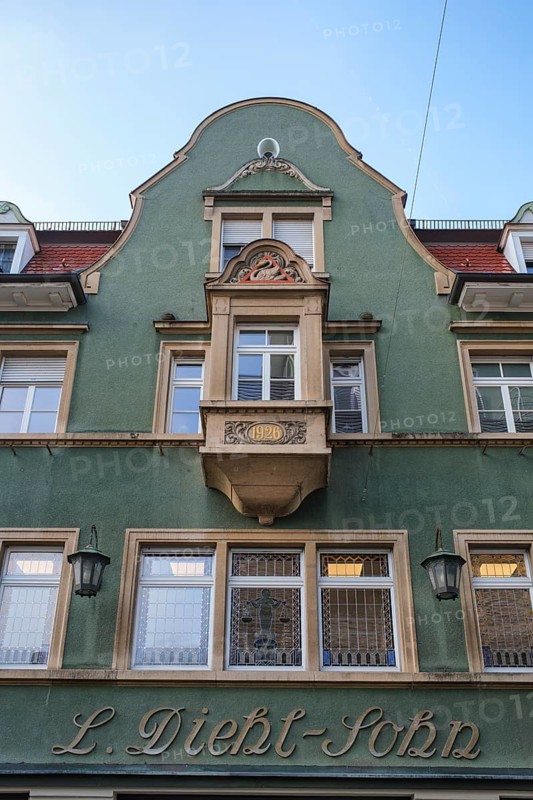 Historic building façade from the Wilhelminian period with green paint and decorative details, Singen am Hohentwiel, Hegau, Konstanz district, Baden-Württemberg, Germany