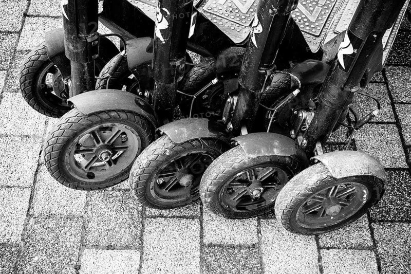 Black and white view of lined up, parked e-scooters on a paved surface, Singen am Hohentwiel, Hegau, Konstanz district, Baden-Württemberg, Germany