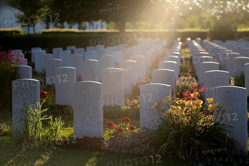 Tombstones, war graves, military graves, flowers, British and German military cemetery, Cimetière militaire britannique, D-Day, Operation Overlord, back light, atmospheric, evening light, Bayeux, Normandy, Calvados, France