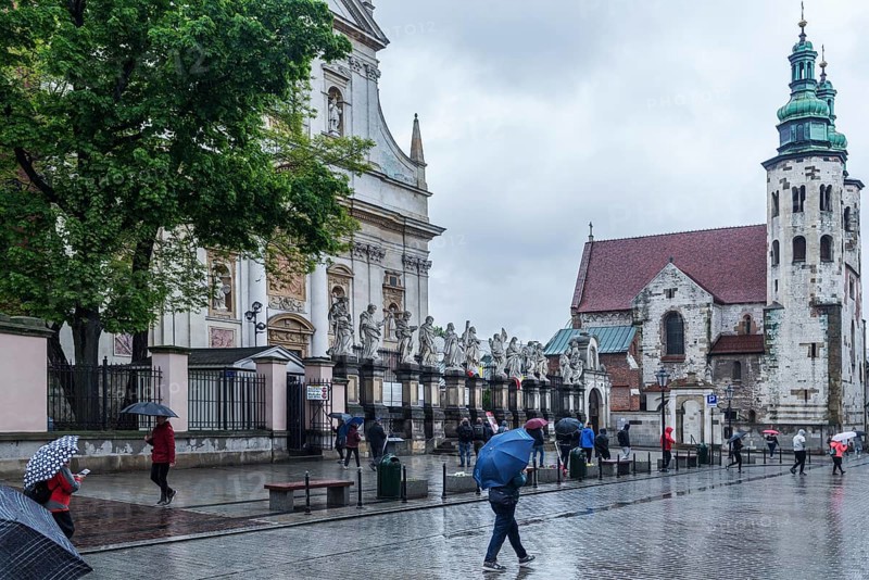 Sculptures of saints in front of St. Peter and Paul Church, St. Andrew's Church on the right, Krakow, Poland