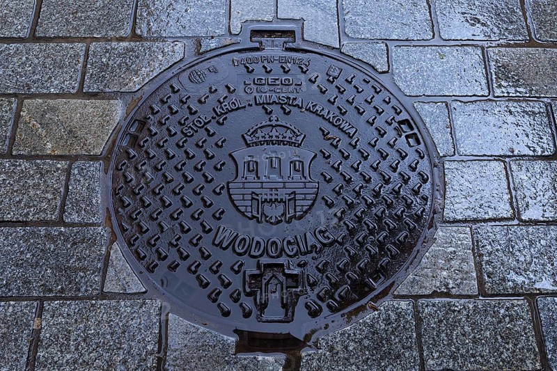 Manhole cover with the coat of arms of Krakow, Krakow, Poland
