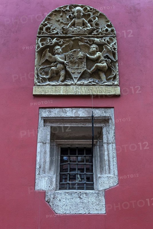 Relief with coat of arms and angels on a coloured house wall, Krakow, Poland
