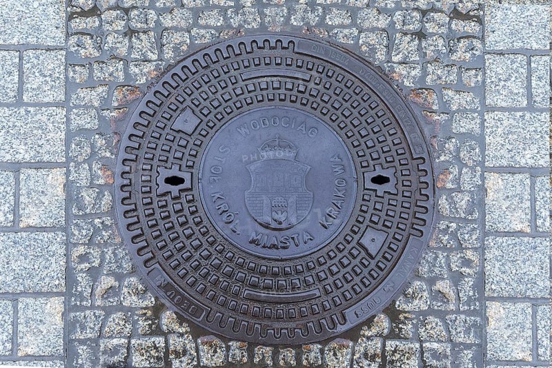 Manhole cover with the coat of arms of Krakow, Krakow, Poland