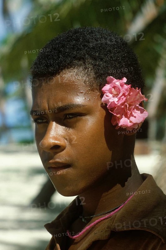 Boy with flowers behind left ear, Tavewa Island, Yasawa archipelago, Fiji