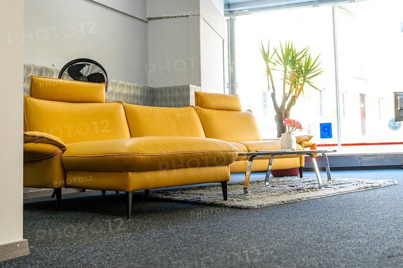 Modern living room with yellow sofa and window front, cozy atmosphere