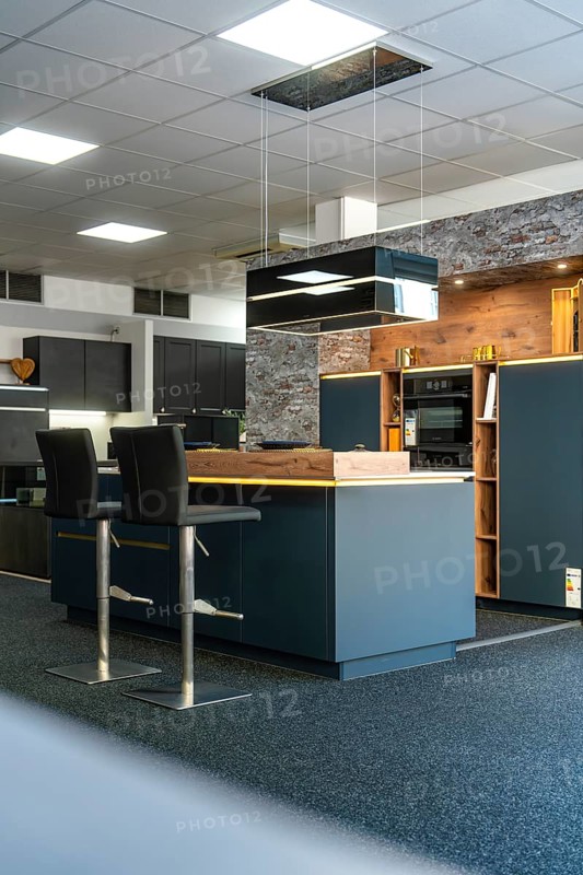 Detail of a modern kitchen with brick wall and stylish lighting