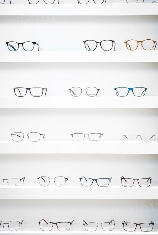 Several pairs of glasses neatly arranged on shelves in an optician's shop, optician, Pforzheim