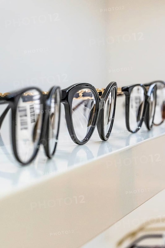 Several black eyeglass frames on a shelf in an optician's shop, optician, Pforzheim