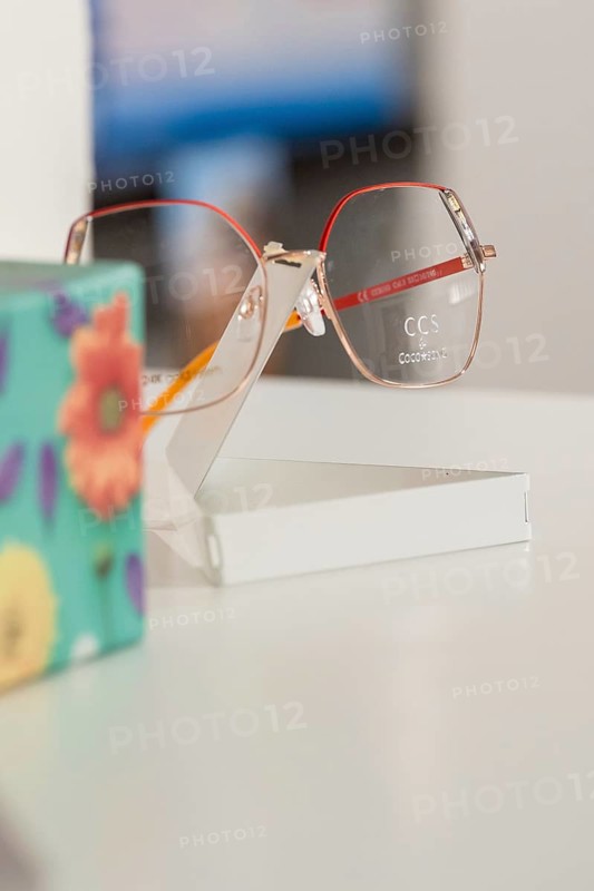 Close-up of stylish glasses next to a colorful floral pattern, optician, Pforzheim