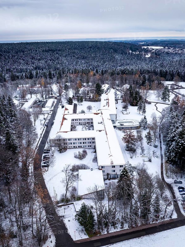 A snow-covered building in the middle of a wooded winter landscape mountain, Rehab Clinic, Schömberg, Black Forest, Germany