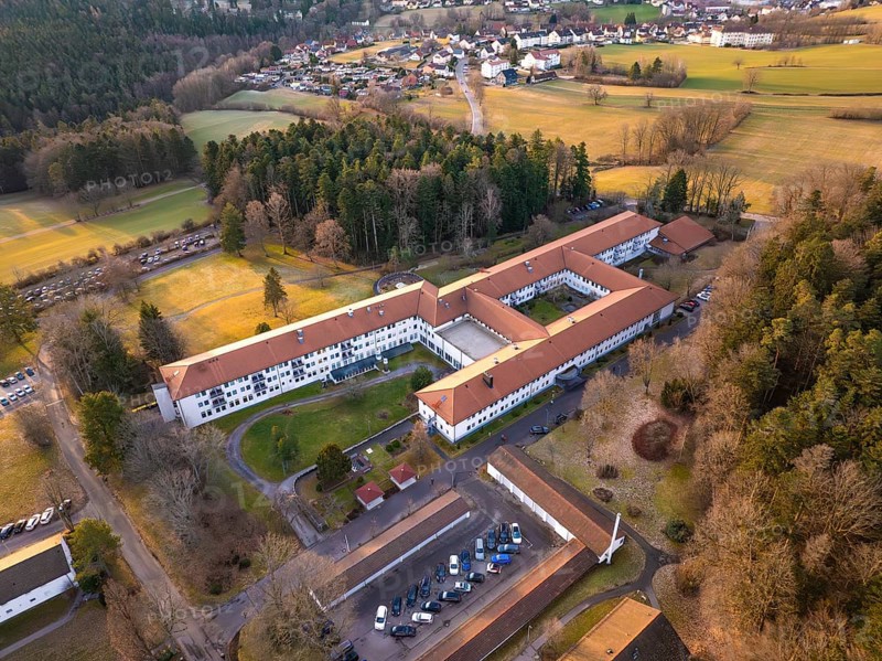 Building complex surrounded by fields in a rural village, from an aerial view, rehab clinic, Schömberg, Black Forest, Germany
