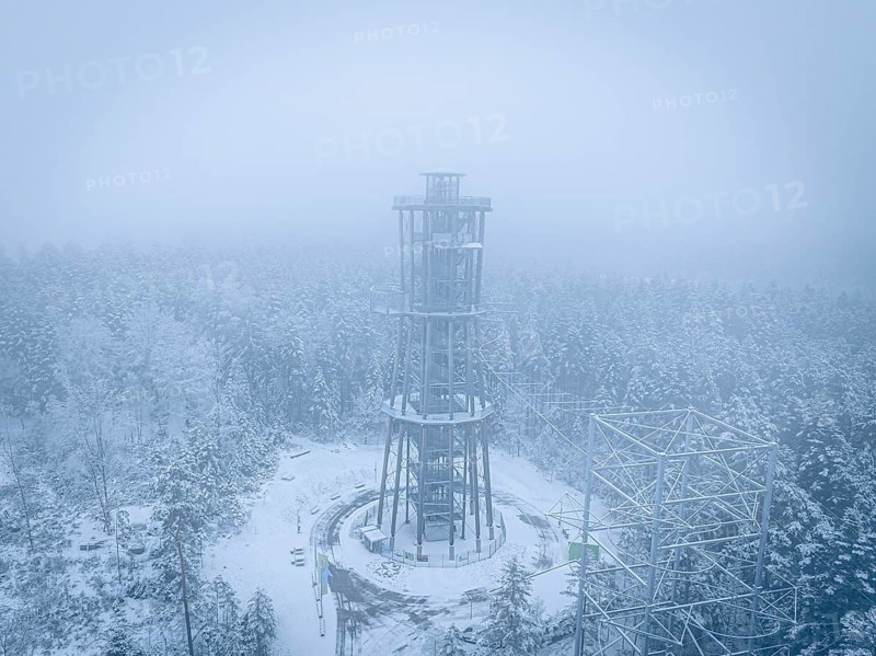 A lonely tower stands in a foggy, snowy forest, Himmelsglück observation tower with Flying Fox, Schömberg, Black Forest, Germany