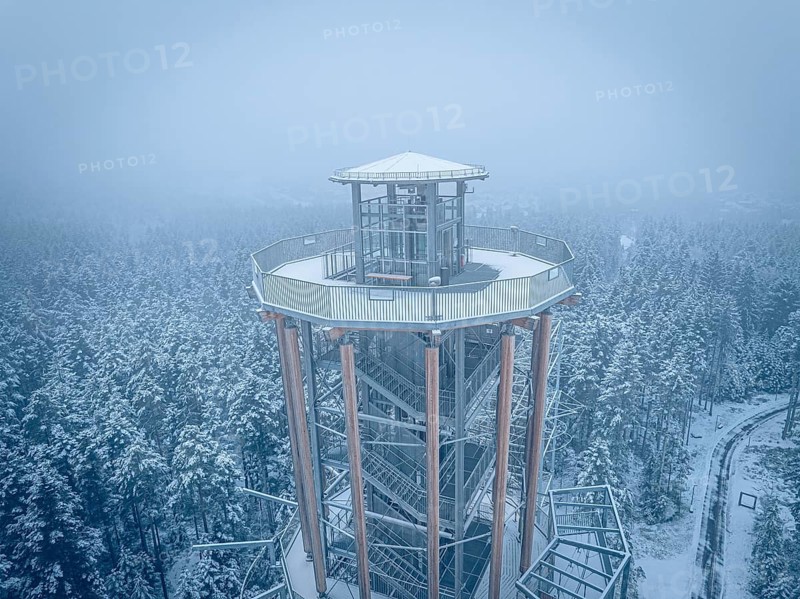 Snow-covered tower above a winter forest in fog, Himmelsglück observation tower with Flying Fox, Schömberg, Black Forest, Germany