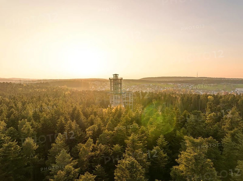An observation tower rises above a green forest under a golden sunset, Himmelsglück observation tower with Flying Fox, Schömberg, Black Forest, Germany