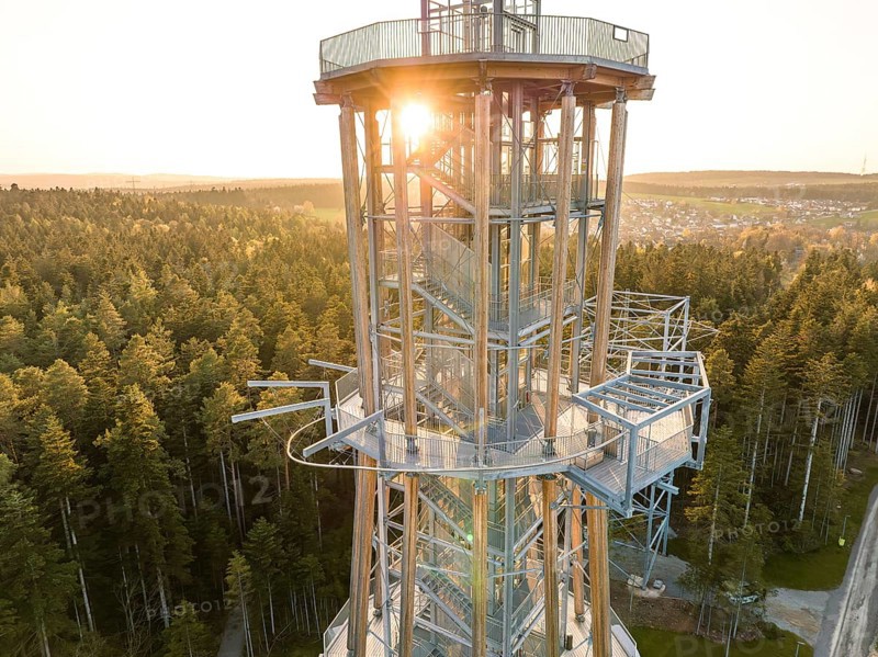 Spire at setting sun surrounded by thick forests, Himmelsglück observation tower with Flying Fox, Schömberg, Black Forest, Germany