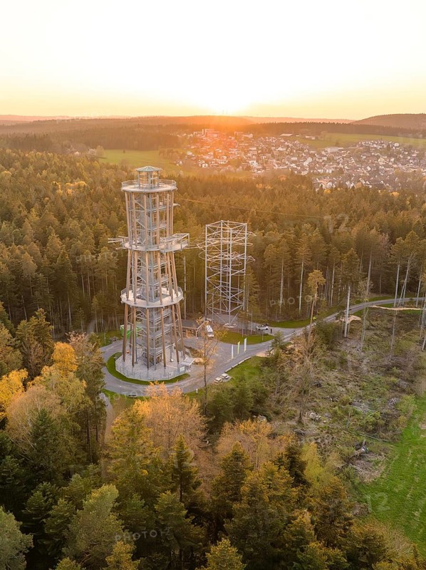 Tower in the forest at sunset, a village visible in the distance, Himmelsglück observation tower with Flying Fox, Schömberg, Black Forest, Germany