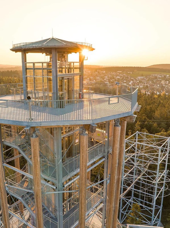 Observation tower with a view of a city in the background at sunset, Himmelsglück observation tower with Flying Fox, Schömberg, Black Forest, Germany