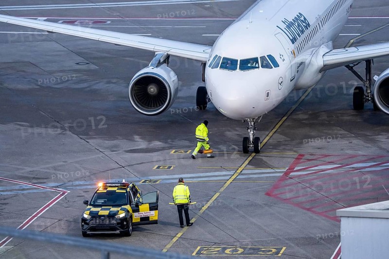 Apron supervision, Lufthansa Airbus is instructed to the parking position at the gate, at Cologne/Bonn Airport, North Rhine-Westphalia, Germany